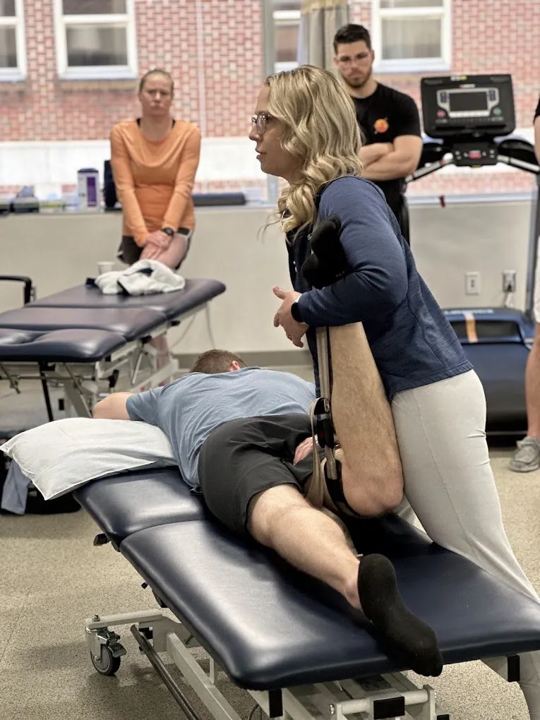 Dr. Tanya Dickson performing a hands-on hip stretch on a patient