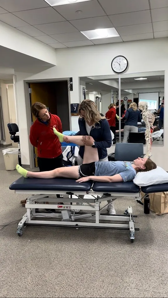 Dr. Tanya Dickson assessing a patient’s hip and leg mobility