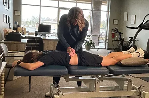 Hands-on manual therapy to a patient’s low back