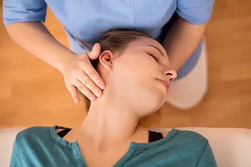 Therapist gently positioning a patient’s head during vertigo treatment